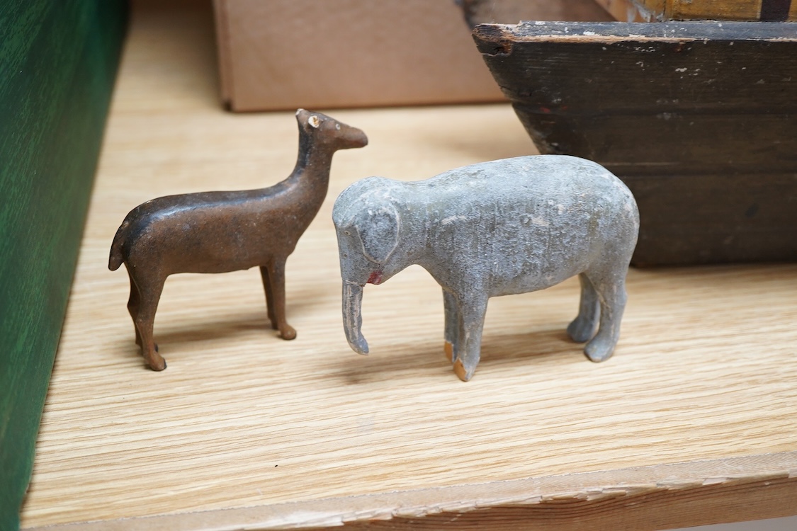 A 19th century German Erzgebirge pine painted Noah's Ark together with a good quantity of carved and painted wooden animals, the ark decorated with trompe l’oeil architectural features, geometric patterns, Gothic windows